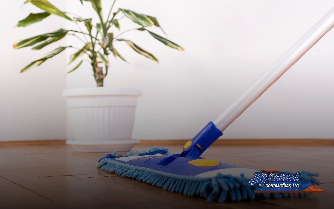 Using a damp microfiber mop to clean vinyl plank floors.